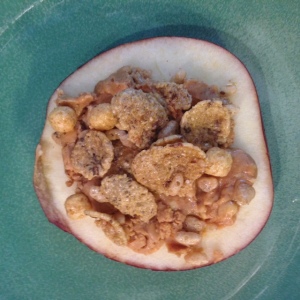 Sliced apple with peanut butter and granola