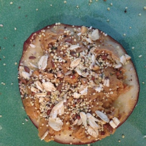 Sliced apple with almond butter and toasted quinoa seed mixture